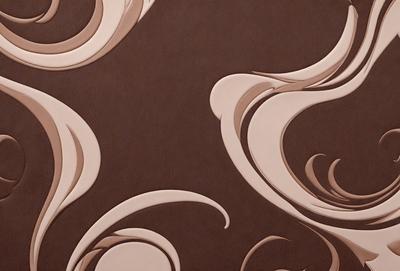The primary subject of the image is a brown and white patterned wallpaper. The setting is a room with a brown and white wallpapered wall. The visual style is a patterned wallpaper, which gives the room a unique and artistic appearance. The dominant colors are brown and white, creating a warm and inviting atmosphere.