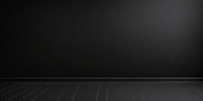 The primary subject of the image is a black wall with a black background. The setting is a room with a wooden floor. The visual style is a black and white photo. The dominant colors are black, and the overall atmosphere is dark and moody.