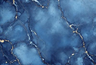 The primary subject of the image is a blue and gold marble wall. The setting is a room with a blue and gold marble wall, which serves as the background. The visual style is a photo, capturing the intricate details of the marble wall. The dominant colors are blue and gold, creating a luxurious and elegant atmosphere.