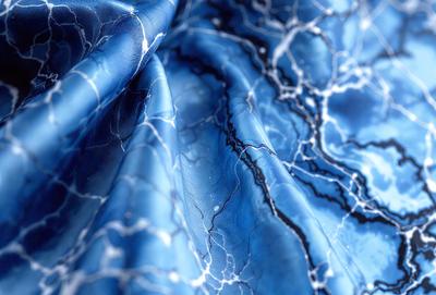 The primary subject of the image is a blue fabric with a pattern of white streaks. The setting is a close-up of the fabric, showcasing its unique design. The visual style is a close-up of the fabric, which gives a detailed view of the pattern. The colors and mood of the image are predominantly blue and white, creating a calm and serene atmosphere.