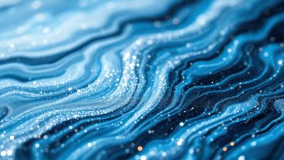 The primary subject of the image is a blue ocean with a rippling surface. The setting is the ocean, and the visual style is a photo. The dominant colors are blue and white, creating a serene and calming atmosphere.