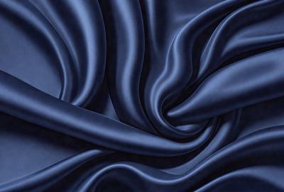The primary subject of the image is a blue fabric, which appears to be a piece of cloth or a curtain. The setting is a dark room, and the visual style is a close-up of the blue fabric. The colors and mood of the image are predominantly dark and moody, with the blue fabric being the main focus.