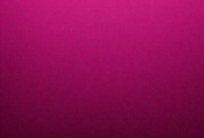 The primary subject of the image is a large, pink wall. The setting is a room with a pink background, and the visual style is a close-up of the wall. The dominant colors in the image are pink, and the overall atmosphere is warm and inviting.