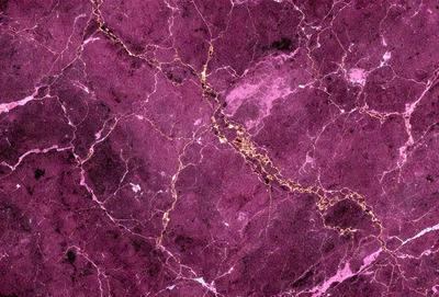 The primary subject of the image is a purple marble wall with gold accents. The setting is a room with a purple marble wall as the main focus. The visual style is a close-up of the marble wall, showcasing its intricate patterns and textures. The colors and mood of the image are predominantly purple and gold, creating a luxurious and elegant atmosphere.