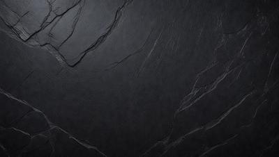 The primary subject of the image is a black surface, possibly a wall or a piece of artwork. The setting or background is a dark, possibly textured, surface. The visual style appears to be a close-up of the black surface, possibly a photo or a digital artwork. The colors and mood of the image are predominantly dark and moody, with the black surface being the main focus.