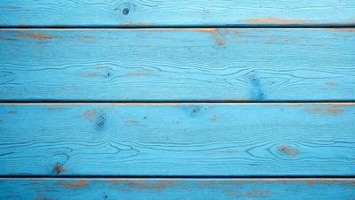 The primary subject of the image is a blue wooden wall. The setting is a room with a blue wooden wall, and the visual style is a photo. The dominant colors are blue and white, creating a calm and serene atmosphere.