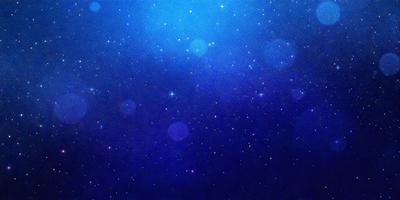 The primary subject of the image is a blue sky filled with stars. The setting is a night sky, and the visual style is a digital art or illustration. The colors and mood of the image are predominantly blue and serene, creating a peaceful and tranquil atmosphere.
