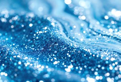 The primary subject of the image is a blue ocean with a wave. The setting is the ocean, and the visual style is a photo. The dominant colors are blue and white, creating a serene and calming atmosphere.