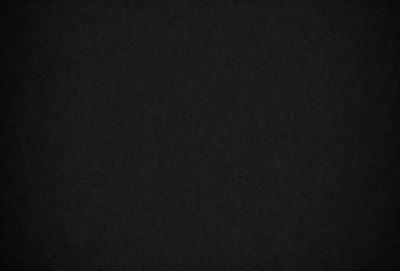 The primary subject of the image is a black background. The setting is a dark room, and the visual style is a black and white photo. The colors and mood are dark and moody, creating a sense of mystery or drama.