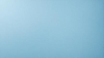 The primary subject of the image is a large, empty blue sky. The setting is a vast, open space with no visible landmarks or objects. The visual style is a natural, outdoor scene with a focus on the sky. The colors and mood are predominantly blue, creating a calm and serene atmosphere.