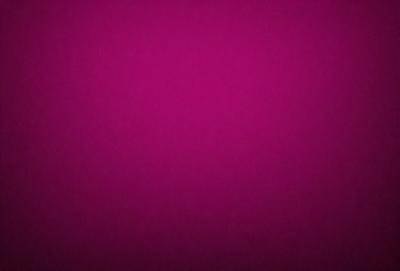 The primary subject of the image is a large, pink surface. The setting is a dark background, which contrasts with the bright pink color of the surface. The visual style appears to be a close-up of the pink surface, possibly a pattern or texture. The colors and mood of the image are predominantly pink, creating a warm and vibrant atmosphere.