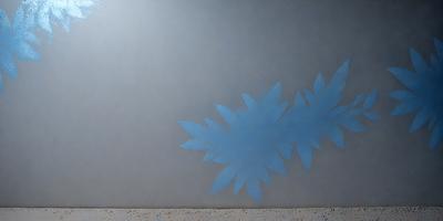 The primary subject of the image is a blue leaf painted on a wall. The setting is a room with a gray background. The visual style is a painting or drawing, and the colors and mood are predominantly blue, creating a calm and serene atmosphere.