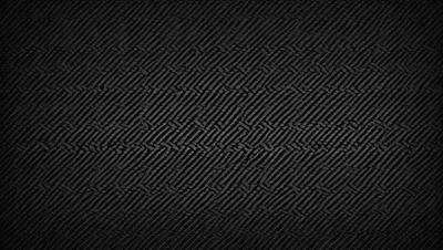 The primary subject of the image is a black and white pattern, which is the main focus of the image. The setting is a black background, and the visual style is a pattern or texture. The colors and mood of the image are predominantly black and white, creating a stark and minimalist atmosphere.