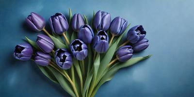 The primary subject of the image is a bouquet of purple tulips. The setting is a blue background, which creates a visually appealing contrast with the purple flowers. The visual style is a close-up of the flowers, showcasing their details and beauty. The colors and mood of the image are predominantly purple, which gives the scene a calm and serene atmosphere.