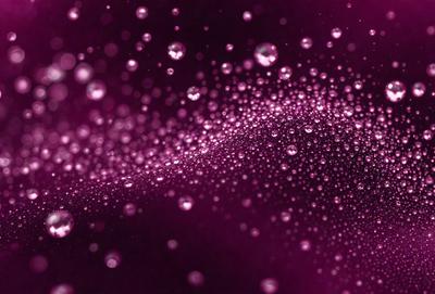 The primary subject of the image is a purple background with a pattern of tiny bubbles. The setting is a dark background, and the visual style appears to be a digital art or illustration. The dominant colors are purple and pink, creating a warm and inviting atmosphere.