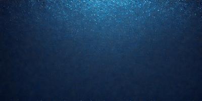 The primary subject of the image is a large body of water, which appears to be a deep blue ocean. The setting is underwater, with the water surface visible. The visual style of the image is a close-up of the water, showcasing the deep blue color and the shimmering surface. The colors and mood of the image are serene and calming, as the deep blue ocean evokes a sense of tranquility and vastness.