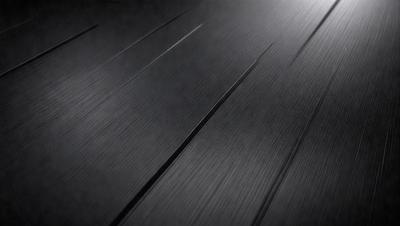 The primary subject of the image is a black surface, possibly a table or a countertop. The setting is a dark room, and the visual style appears to be a close-up of the black surface. The colors and mood of the image are predominantly dark and moody, with the black surface being the main focus.