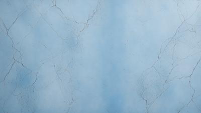 The primary subject of the image is a blue wall with a cracked and peeling texture. The setting is a room with a blue background. The visual style is a close-up of the wall, showcasing its unique texture. The colors and mood of the image are predominantly blue, creating a calm and serene atmosphere.