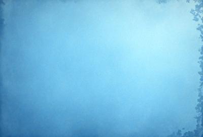 The primary subject of the image is a large, open, and cloudy blue sky. The setting is a vast, empty space with no visible landmarks or objects. The visual style is a natural, outdoor scene with a focus on the sky. The colors and mood are predominantly blue, creating a calm and serene atmosphere.