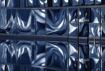 The primary subject of the image is a large glass window with a reflective surface. The setting is a building with a reflective glass wall, which creates a visually striking scene. The visual style of the image is a combination of photo and digital art, as the glass window appears to be a reflection of the building's interior. The colors and mood of the image are predominantly blue, creating a calm and serene atmosphere.