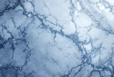 The primary subject of the image is a marble-like surface with a blue and white color scheme. The setting is a bathroom, with the marble-like surface being the main focus of the image. The visual style is a close-up of the marble-like surface, showcasing its intricate patterns and textures. The colors and mood of the image are predominantly blue and white, giving it a clean and elegant appearance.