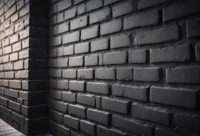 The primary subject of the image is a brick wall. The setting is a dark room, and the visual style is a photo. The dominant colors are black and grey, creating a moody atmosphere.