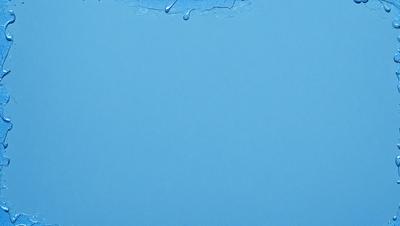 The primary subject of the image is a blue background with a few drops of water on it. The setting appears to be a white surface, possibly a wall or a piece of paper. The visual style of the image is a close-up of the blue background with the drops of water, creating a sense of depth and focus. The colors and mood of the image are predominantly blue, with the drops of water adding a touch of white and a sense of movement.