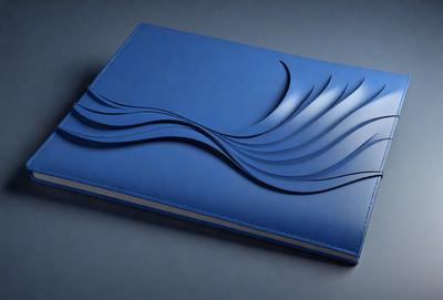 The primary subject of the image is a blue book with a wave design on the cover. The setting is a gray background, which provides a clean and minimalist look. The visual style is a combination of digital art and illustration, as the wave design is intricately crafted and adds a sense of depth and texture to the book cover. The colors and mood of the image are predominantly blue, which gives the book a calm and soothing appearance.