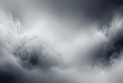 The primary subject of the image is a cloudy sky. The setting is a dark, cloudy day with a gloomy atmosphere. The visual style is a photo, capturing the cloudy sky in its natural environment. The colors and mood are predominantly dark and moody, with the clouds creating a dramatic backdrop.