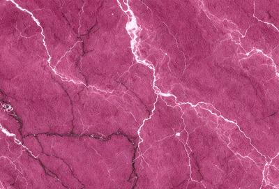 The primary subject of the image is a close-up of a purple marbled wall. The setting is a room with a purple marbled wall, which serves as the background. The visual style is a close-up of the marbled wall, showcasing its texture and color. The dominant colors are purple and pink, creating a warm and inviting atmosphere.