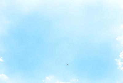 The primary subject of the image is a cloud in the sky. The setting is a clear blue sky, and the visual style is a photo. The cloud is the main focus of the image, and the overall atmosphere is serene and peaceful.