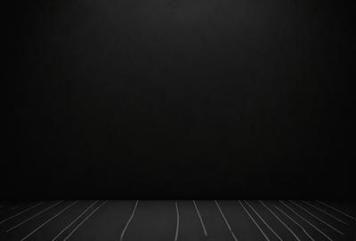 The primary subject of the image is a black wall with a white line on it. The setting is a dark room, and the visual style is a black and white photo. The dominant colors are black and white, creating a moody atmosphere.