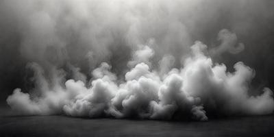 The primary subject of the image is a cloud of smoke, which is the main object, scene, or focus of the image. The setting is a dark, cloudy sky, and the visual style is a black and white photo. The dominant colors are shades of gray, and the overall atmosphere is dramatic and moody.