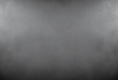 The primary subject of the image is a gray, foggy sky. The setting is a cloudy, overcast day, with no visible landmarks or objects. The visual style is a black and white photo, which adds a sense of depth and moodiness to the scene. The colors and mood are predominantly dark and moody, with the gray sky and fog creating a somewhat somber atmosphere.