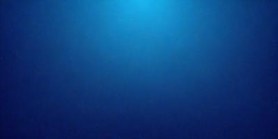 The primary subject of the image is a large body of water, which appears to be a deep blue ocean. The setting is a vast, open space with no visible land or objects. The visual style is a realistic representation of the ocean, with no indication of digital manipulation or artistic elements. The colors and mood of the image are predominantly blue, creating a serene and tranquil atmosphere.