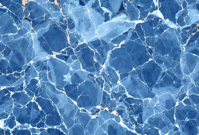 The primary subject of the image is a blue and gold marbled tile. The setting is a blue and gold marbled tile surface, which serves as the background. The visual style is a close-up of the marbled tile, showcasing its intricate design. The colors and mood of the image are predominantly blue and gold, creating a warm and elegant atmosphere.
