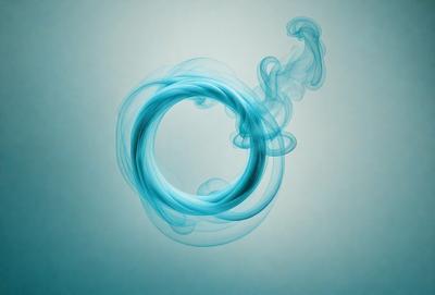 The primary subject of the image is a blue circle, which appears to be a smoke ring or a blue circle of smoke. The setting is a blue background, which complements the blue circle. The visual style is a close-up of the blue circle, emphasizing its shape and texture. The colors and mood of the image are predominantly blue, creating a calm and serene atmosphere.