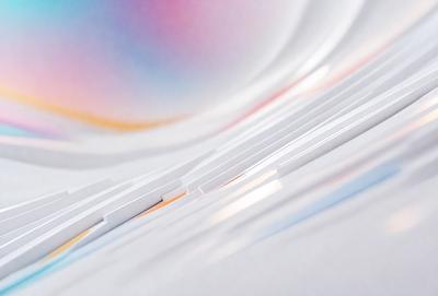 The primary subject of the image is a stack of white papers. The setting is a white background, which creates a clean and minimalist appearance. The visual style is a close-up of the papers, showcasing their texture and details. The colors and mood of the image are predominantly white, giving it a simple and uncluttered feel.