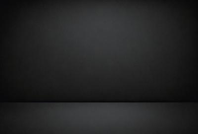 The primary subject of the image is a black background. The setting is a dark room, and the visual style is a black and white photo. The colors and mood are dark and moody, creating a sense of mystery or drama.