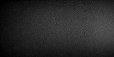 The image is a black and white photo of a wall. The wall appears to be textured, and the photo has a vintage feel to it. The primary subject is the wall, and the setting is indoors. The visual style is a black and white photo, which gives the image a classic and timeless appearance. The colors and mood of the image are predominantly black and white, creating a sense of nostalgia and simplicity.
