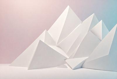 The primary subject of the image is a large stack of white paper, which appears to be a mountain of paper. The setting is a white background, and the visual style is a photo. The colors are predominantly white, giving the image a clean and minimalist appearance. The overall mood of the image is one of simplicity and focus on the paper mountain.
