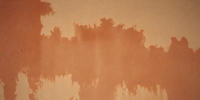 The primary subject of the image is a large, orange, and brown painting on a wall. The painting appears to be a mix of textures and colors, creating a unique and visually interesting piece. The setting is a room with a wall that serves as the canvas for the painting. The visual style of the image is a combination of artistic expression and digital art, as it is a digital painting. The dominant colors in the painting are orange and brown, giving it a warm and earthy atmosphere.