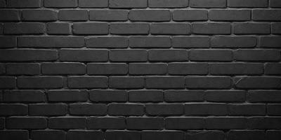 The primary subject of the image is a black brick wall. The setting is a dark room, and the visual style is a close-up of the brick wall. The colors and mood of the image are predominantly dark, with the black brick wall being the main focus.