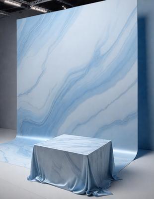 The primary subject of the image is a white table with a blue marble top. The table is placed in front of a blue wall, which serves as the setting or background. The visual style of the image is a photo, capturing the details of the table and the wall. The colors and mood of the image are predominantly blue, creating a calm and serene atmosphere.