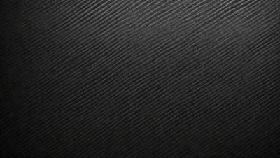 The primary subject of the image is a black and white patterned fabric. The setting is a black background, which contrasts with the patterned fabric. The visual style is a close-up of the fabric, showcasing its intricate design. The colors and mood of the image are predominantly black and white, giving it a classic and timeless appearance.