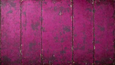 The primary subject of the image is a wooden surface with a purple color. The setting is a room with a wooden floor, and the visual style appears to be a photo. The dominant colors are purple and brown, creating a warm and inviting atmosphere.