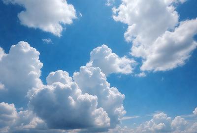 The primary subject of the image is a cloudy blue sky filled with numerous white clouds. The setting is a vast open sky, and the visual style is a natural, outdoor scene. The colors and mood of the image are predominantly blue and white, creating a serene and peaceful atmosphere.
