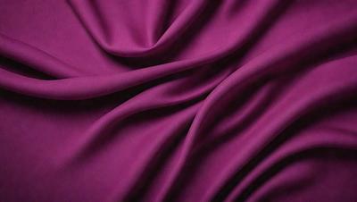 The primary subject of the image is a purple fabric, which is the main object, scene, or focus of the image. The setting or background is a purple cloth, and the visual style is a close-up of the purple fabric. The colors and mood of the image are predominantly purple, creating a calm and soothing atmosphere.