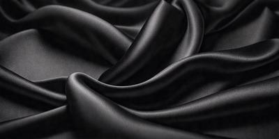 The primary subject of the image is a close-up of a black fabric, possibly a piece of clothing or a curtain. The setting is a dark room, and the visual style appears to be a photo. The colors and mood of the image are predominantly dark and moody, with the black fabric being the main focus.