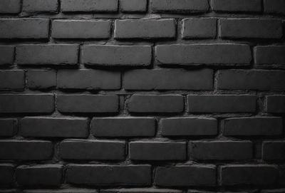 The primary subject of the image is a brick wall. The setting is a dark room, and the visual style is a black and white photo. The dominant colors are black and white, creating a moody atmosphere.